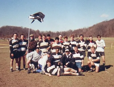 An early Lions squad posed on the pitch in hooped jerseys, one player held aloft in a lineout lift behind them