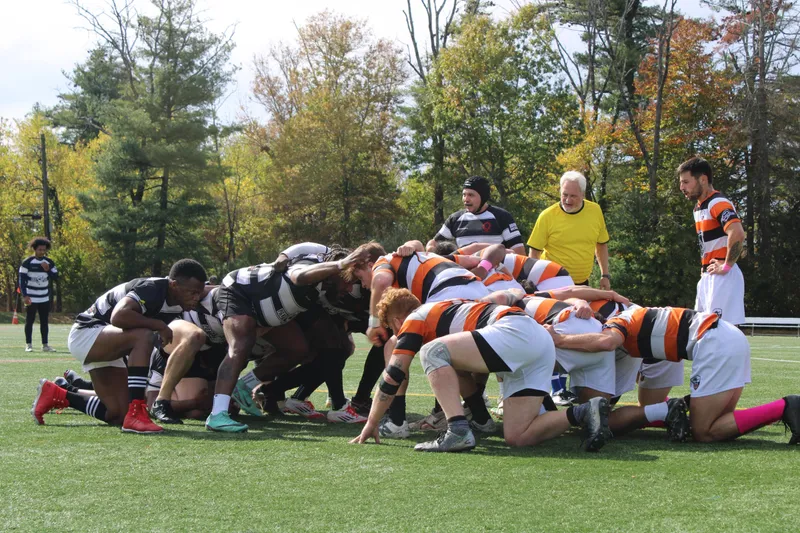 The Lions pack binds for a scrum against opponents in orange and black